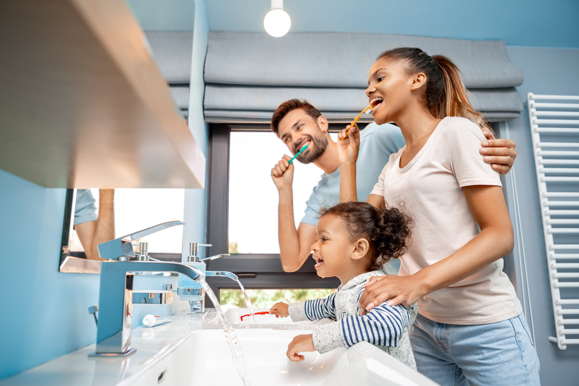 Family brushing teeth together